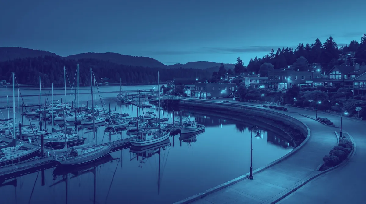 Harbour at blue hour with sailboats and a seawall walk